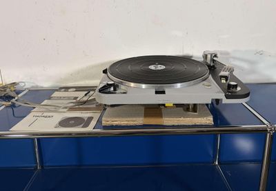 a record player sitting on top of a blue table