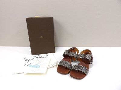 sandals are on a table next to a box and a card