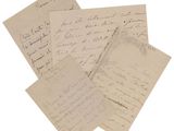 several old letters are stacked on top of each other on a white surface