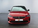 the front of a red opel parked in a showroom