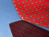 several ties are laid out on a blue surface with red and black designs