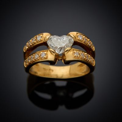 a close up of a diamond ring on a black surface