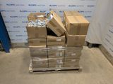 boxes stacked on pallets in front of a wall with a sign in the background
