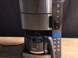 a coffee maker that is sitting on a wooden table