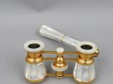 two white and gold bathroom faucets on a gold stand