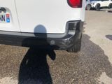 a shadow of a person standing in front of a white truck