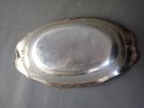 a silver plate on a table with a black table cloth