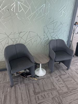 two chairs that are next to each other in a room