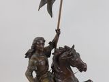 statue of a man on a horse holding a flag and a flag pole