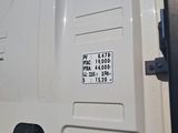 a close up of a white van door with a black handle