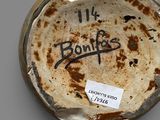 a brown and white bowl with writing on it