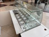 a glass display case with a lot of food inside of it