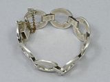 silver plated bracelet with links and a clasp on a white background