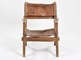 a brown leather chair on a white background