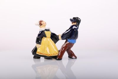 a figurine of a man and a woman holding hands