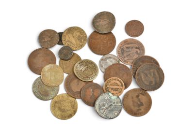 a pile of old coins on a white surface