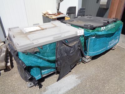 two coolers that are sitting on the side of a building