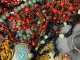 a pile of assorted beads and necklaces on a table