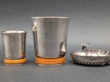 two cups and a bowl sitting on a table