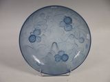 a blue plate with blue flowers on it on a stand
