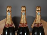 two bottles of champagne sitting in a wooden box
