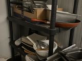 a shelf with pots and pans on it in a kitchen