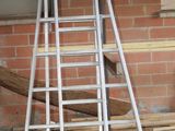 many ladders that are stacked up in a room