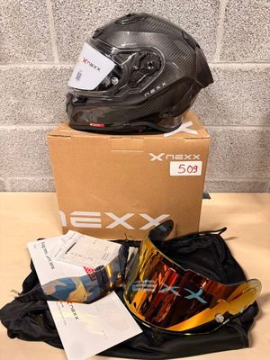 helmet and goggles on a table next to a cardboard box