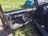 a car that has been badly damaged and is parked on the side of the road