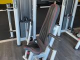a gym room with a row of machines and other equipment