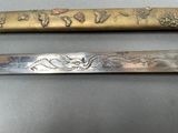 two different types of knives on display on a table