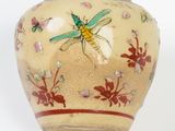 a small vase with a dragonfly painted on it