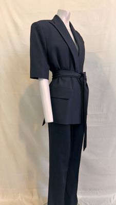 the mannequin is wearing a black suit with a belt