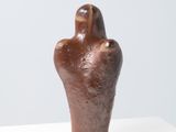 sculpture of a human hand on a white surface
