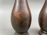 two vases with designs on them on a table