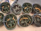 several helmets are lined up on a table in a warehouse
