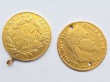 two pieces of gold coins are shown on a white surface