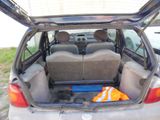 the back of a car with its trunk open and a seat folded down
