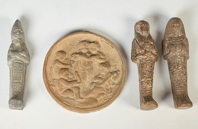 Plusieurs objets anciens sont exposés sur une surface blanche