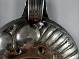 a close up of a metal object on a white surface