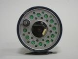 a close up of a fly reel on a white surface