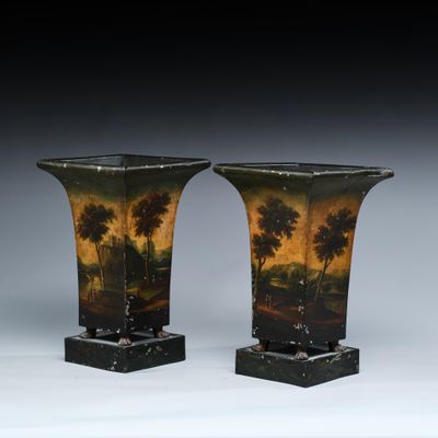 pair of vases with a landscape painted on them sitting on top of a table
