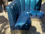 a blue couch that is sitting in the middle of the street
