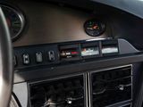 a car dashboard with a clock and various gauges on it