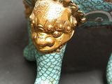 a blue and gold statue of an elephant with a dragon on it ' s back