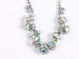 a necklace and earring set on a white surface