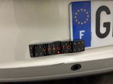 a sticker on the back of a white car