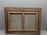 an old wooden window with two glass panes on a white surface