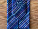 a close up of a tie on a wooden table