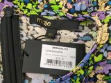 a close up of a floral shirt with a zipper on it